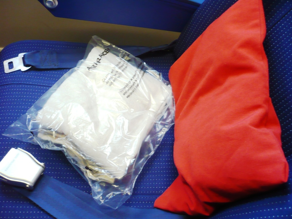 Almohada y cobija en Y/C para cada uno de los pasajeros. En vuelo repartirían un menú pequeño individual y un Amenity Kit... para Y/C!!